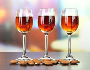 Glasses of amaretto liquor and roasted almonds,