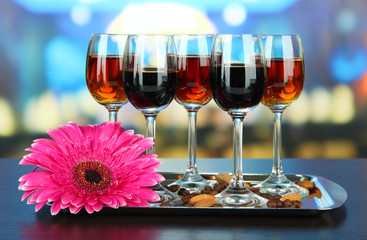 Glasses of liquors with almonds and coffee grains,