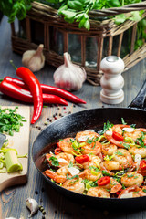 Freshly fried shrimps on old pan