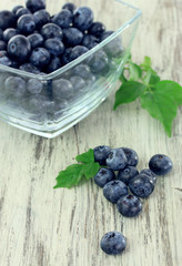 Blueberries in glass bowl on wooden table