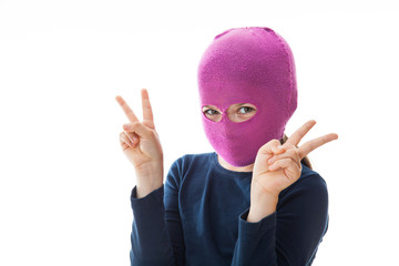 Girl in gangster mask giving 'Victory' sign