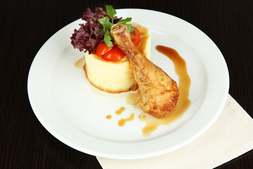 Small portion of food on big plate on wooden table