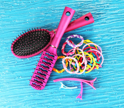 Scrunchies, hairbrush  and  hair - clip   on a blue background
