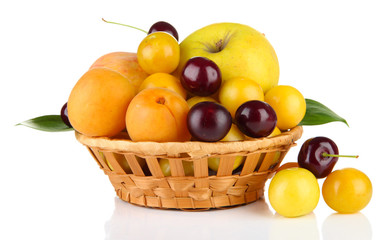Bright summer fruits in basket isolated on white