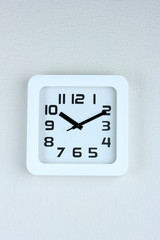 Office clock on color wall background