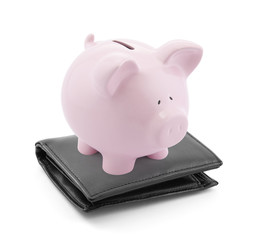 Piggy bank with black leather wallet on white