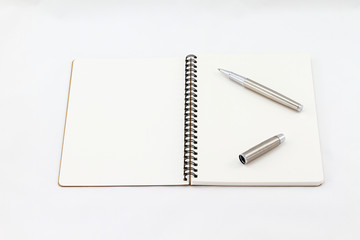Notebook and Silver fountain pen isolated on white background