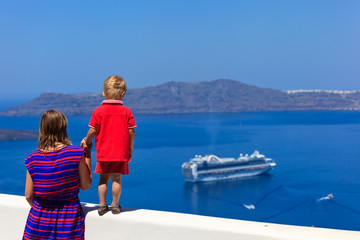 Fototapeta na wymiar family looking at Santorini, Greece