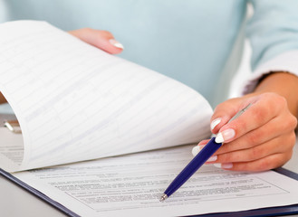 businesswoman giving you the pen and the contract to sign