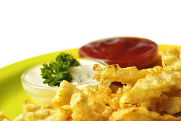 French fries and chicken on the white isolated background