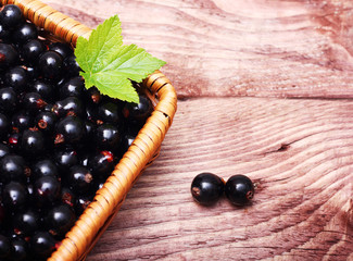 Black currants isolated on wooden background