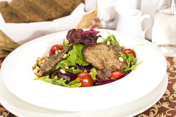 rabbit liver salad with arugula in a restaurant