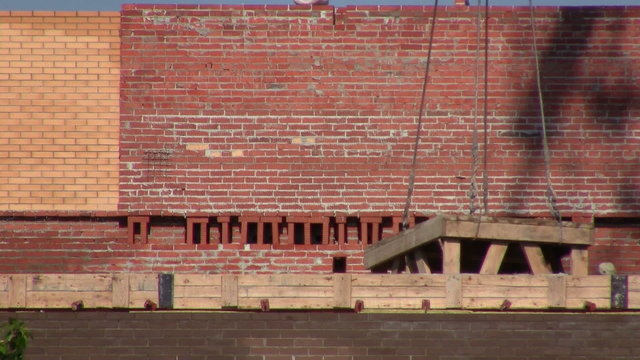 Works at the construction site. Constructing a new building
