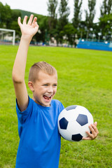 Obraz premium Screaming boy playing football.