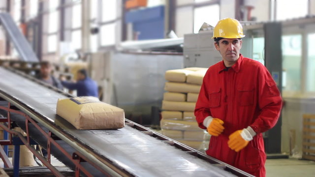 Worker controls sacks of sugar in Warehouse