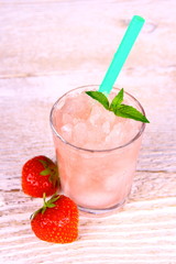 Strawberry slush in glass with straw and mint