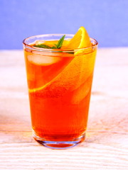 Orange cocktail on blue background