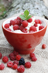 Raspberries with cream,selective focus