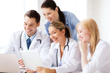 group of doctors looking at tablet pc