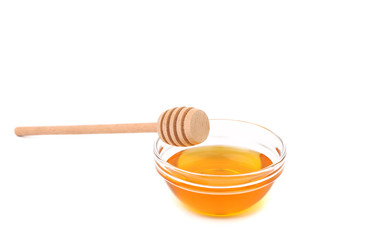 Wooden spoon on bowl with honey.