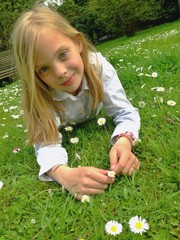 young girl resting on lawn