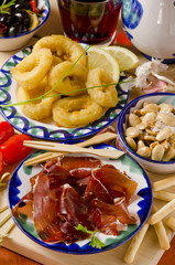 Spanish Cuisine. Assorted tapas on ceramic plates.