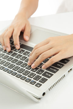 Female hands typing on laptop