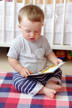baby with book at home