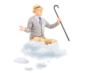 Happy senior man floating on a cloud and spreading arms