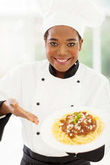 professional female african chef presenting pasta