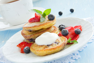 Pancakes with blueberries and strawberries.