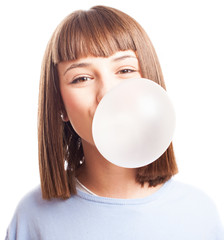 girl doing a bubble with a chewing gum on a white background