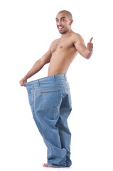 Fototapeta premium Man in dieting concept with oversized jeans