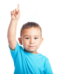 child pinting up with the finger on a white background