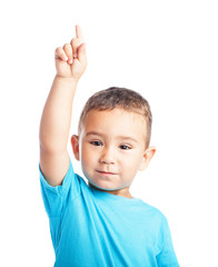 child pinting up with the finger on a white background