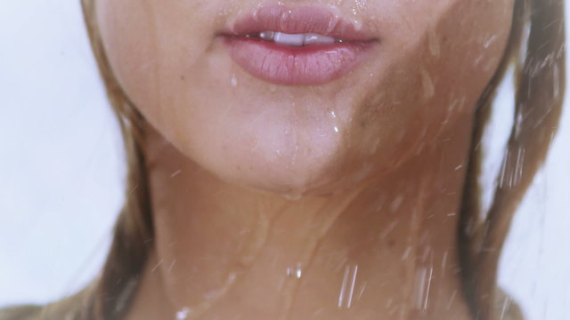 Young woman taking a shower in slow motion