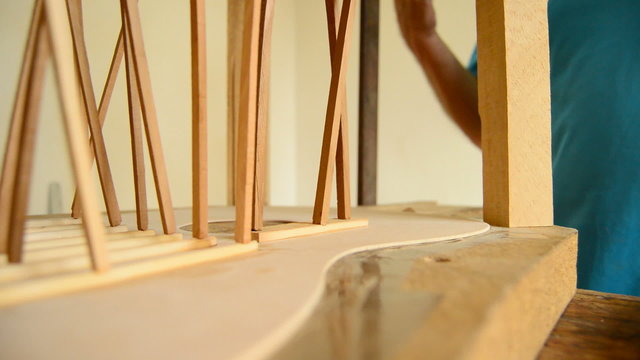 Luthier manufacturing a guitar.