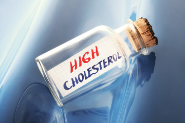 Health concept of a message in a bottle "high cholesterol"