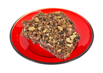 Cocoa granola honey peanut bars on red plate