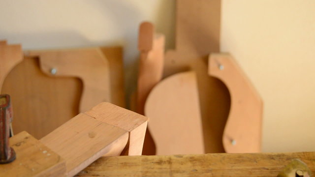 Luthier making a structure guitar with chisel