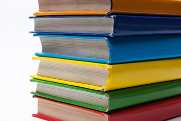 Colorful real books on white background