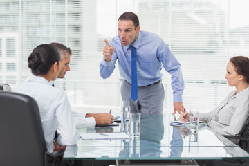 Angry executive pointing out his employee