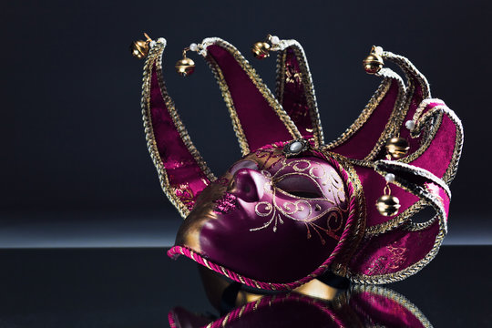 Venetian Mask With Bells On A Mirror Table