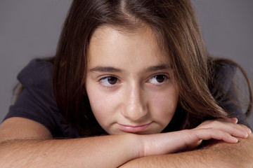 Young teenage girl, looking sad and lonely