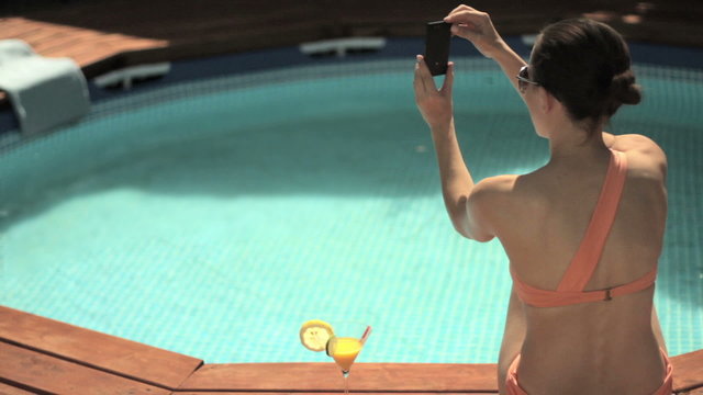 Young woman taking photo during summer holidays