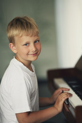 little funny boy plays piano