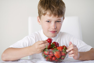 little funny boy with strawberries