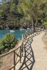 Obraz premium A pathway with fencing along the coast at katranci bay, Turkey
