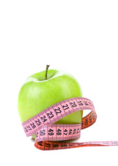 fresh apple with measuring tape.