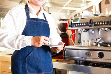 Asian Coffeeshop - barista presents coffee